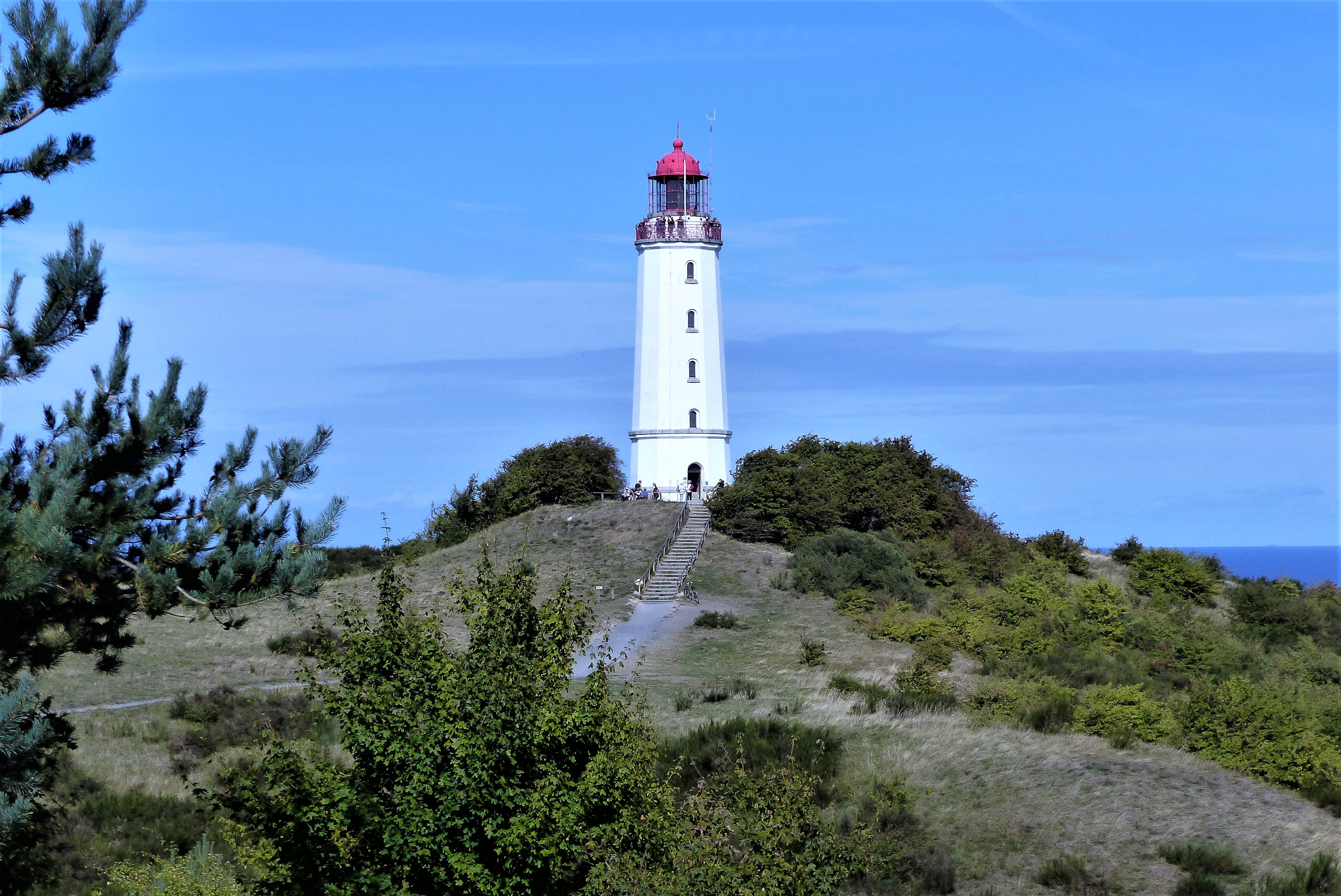White Dornbusch lighthouse rising from grassy hills above Germany's Hiddensee island in the Baltic Sea