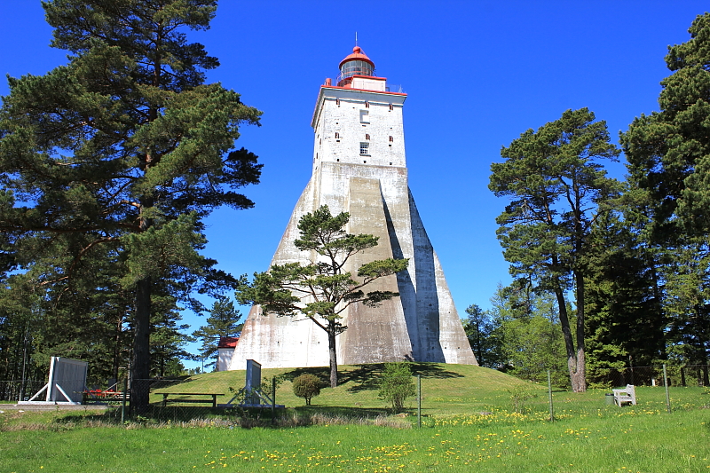 White stone Kõpu lighthouse rising above pine trees on Hiiumaa, Estonia
