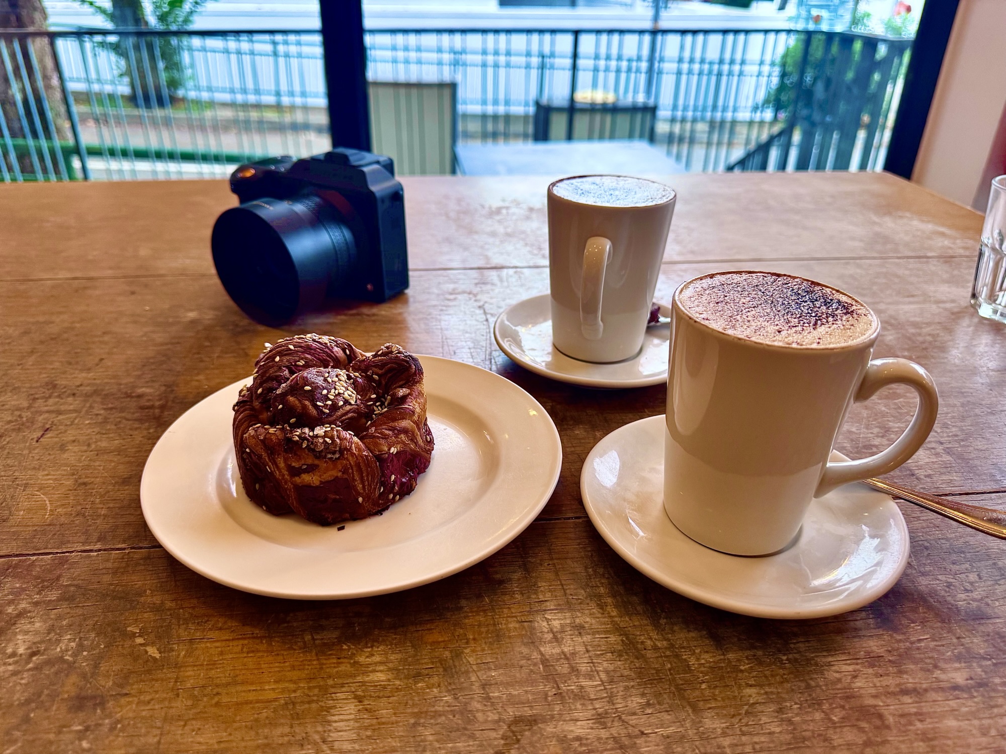 Hasselblad camera with a 28mm lens beside coffee and cakes at a café in Namly, Bukit Timah.