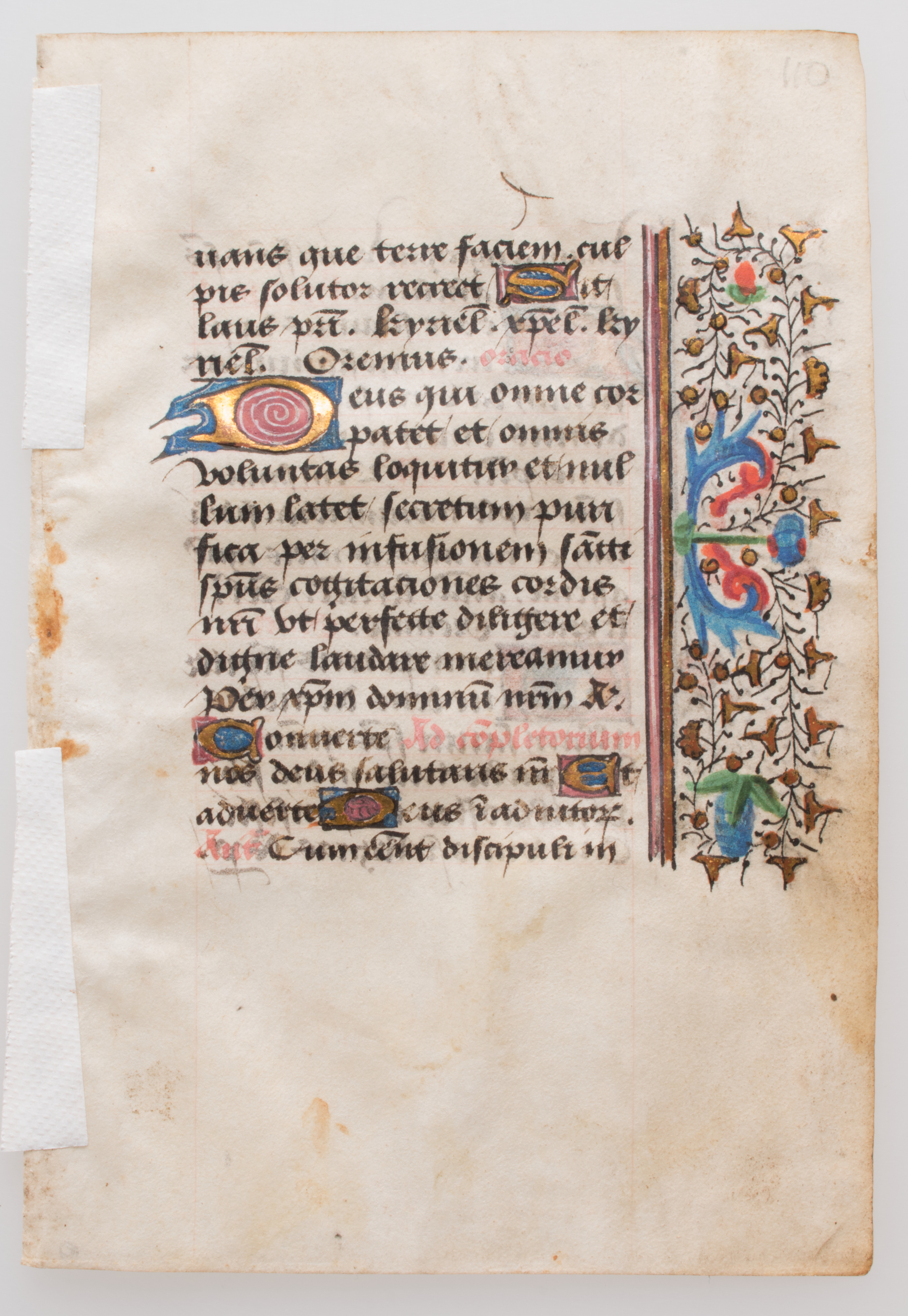 Fifteenth-century French book-of-hours manuscript leaf with semi-cursive handwritten text and decorated floral margin.